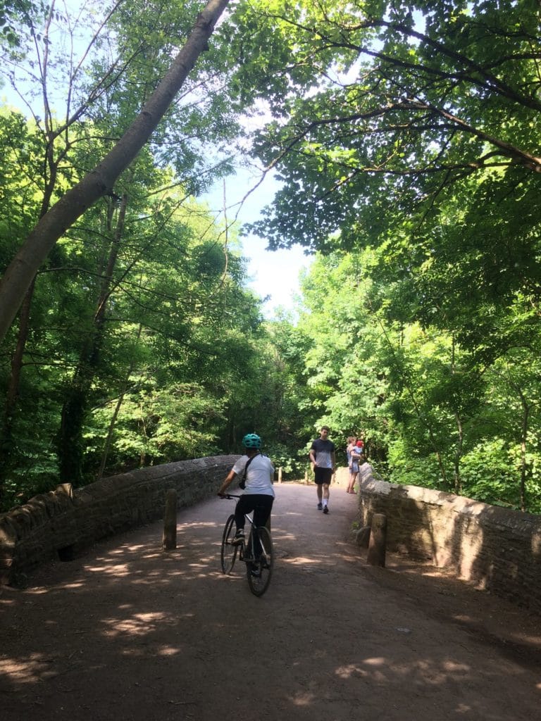 cyclist going over a stone bridge